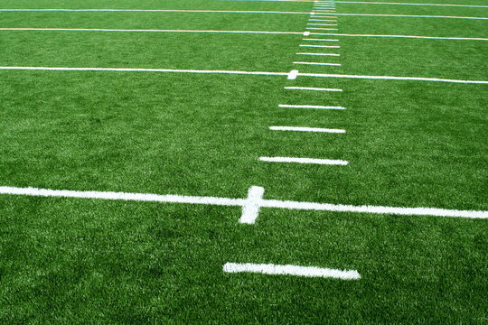 Athletic field turf marked with white yard lines and hash marks